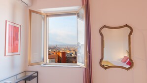 A room with a large window, a mirror, and a framed picture on the wall. - Panoramic 3-bed Apartment in Catania City (Catania)