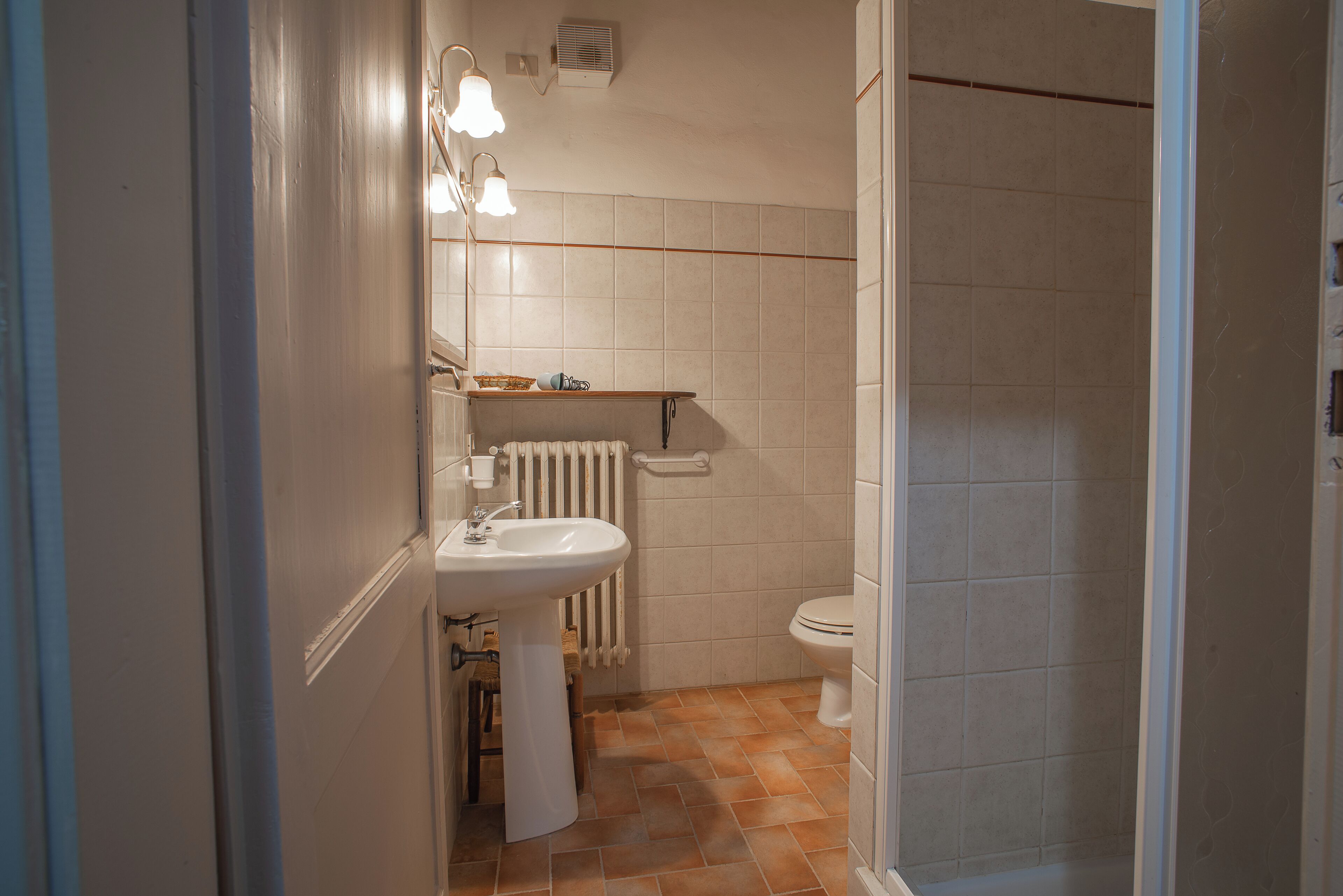 A bathroom with a sink, toilet, and shower.