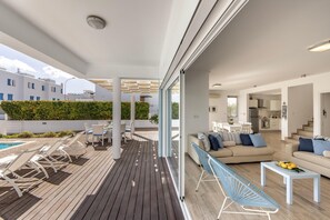 Relax in a comfortable living area with a sofa set and dining table, perfect for socializing or unwinding.