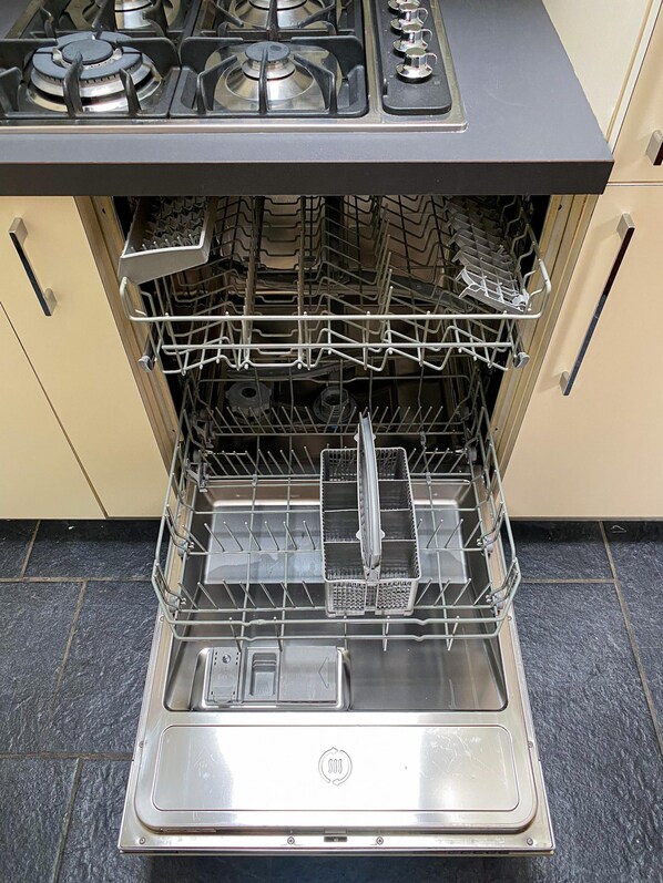 A stainless steel dishwasher with a control panel above it, set in a kitchen with beige cabinetry and a tiled floor. - Il Camino Felice - 201 Autodromo F1 Villa Reale (Monza)