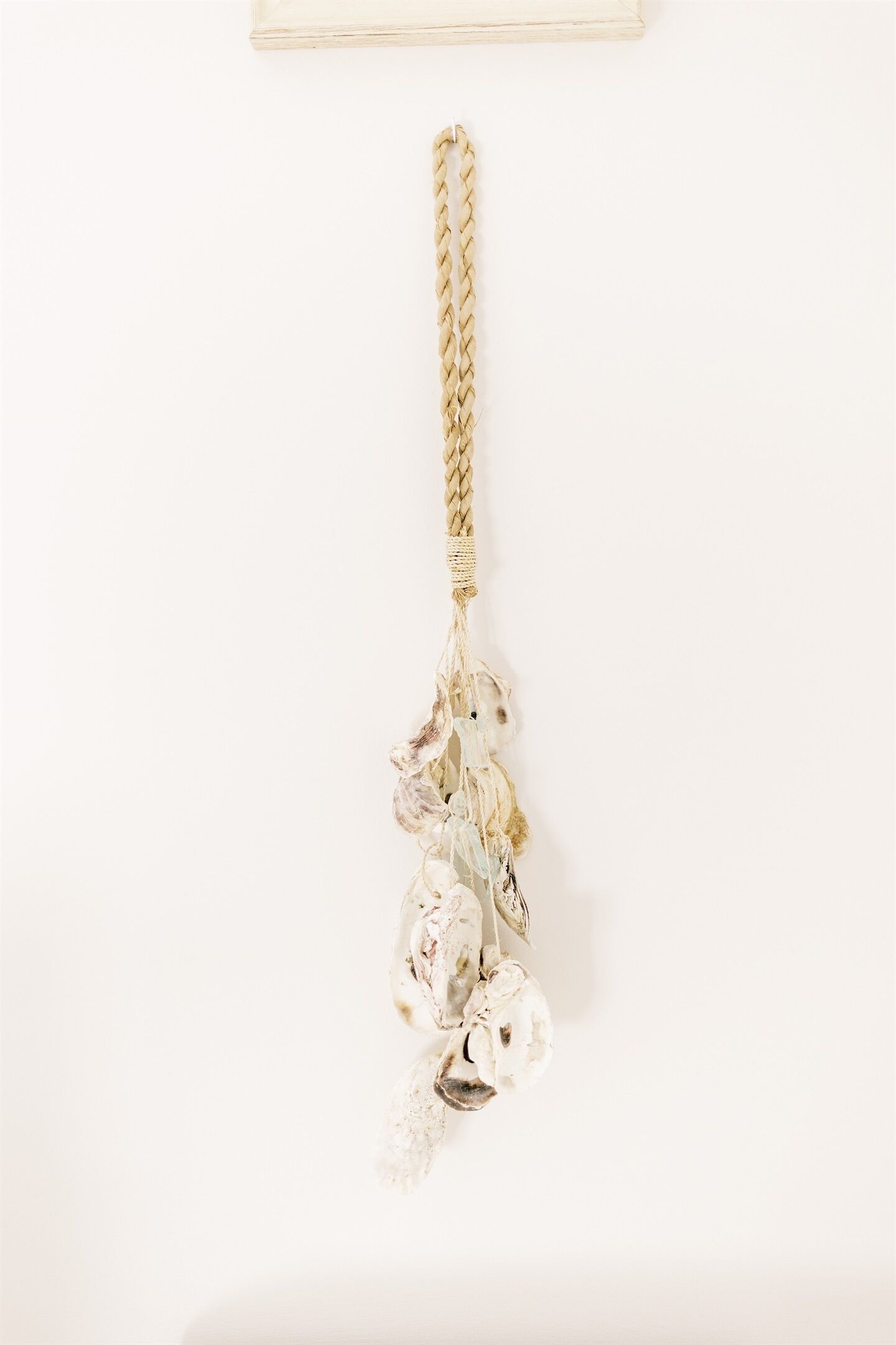 A gold braided keychain with a tassel and a key.