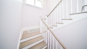 A staircase with white railings and wooden steps.