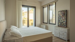 A bedroom with a bed, a window, a radiator, and a cabinet. - Onda 8, Emma Villas - Four Bedroom Villa, Sleeps 8 (Scacciano)
