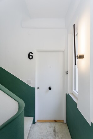 Enter room 6 through the secure door with a modern handle.