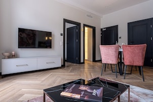 Deluxe Apartment | Living area | 50-inch flat-screen TV with satellite channels, TV