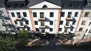 A multi-story building with a white facade, multiple balconies with flower boxes, and a sign reading "CARVA." - Carvala Boutique Apartments (Czestochowa)