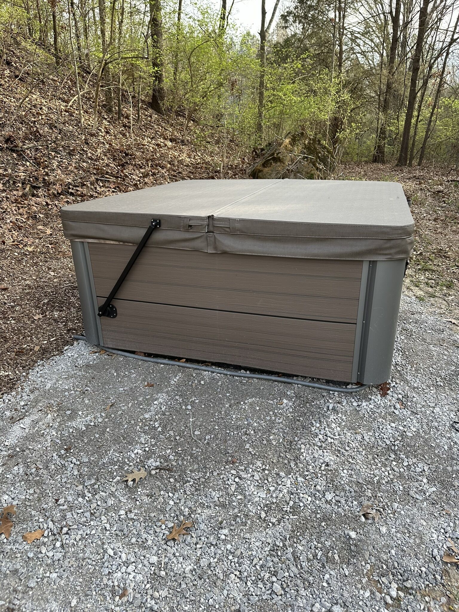 A portable storage unit with a hinged lid, a handle, and a locking mechanism.