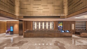 A modern lobby with a central reception desk, wooden paneling, and a digital information kiosk. - Crystal Orange Hotel Suqian Sucheng Government (Suqian)