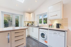 Fridge, microwave, oven, stovetop - This 5-bedroom house exudes an aura of openness and comfort.  (Coventry)