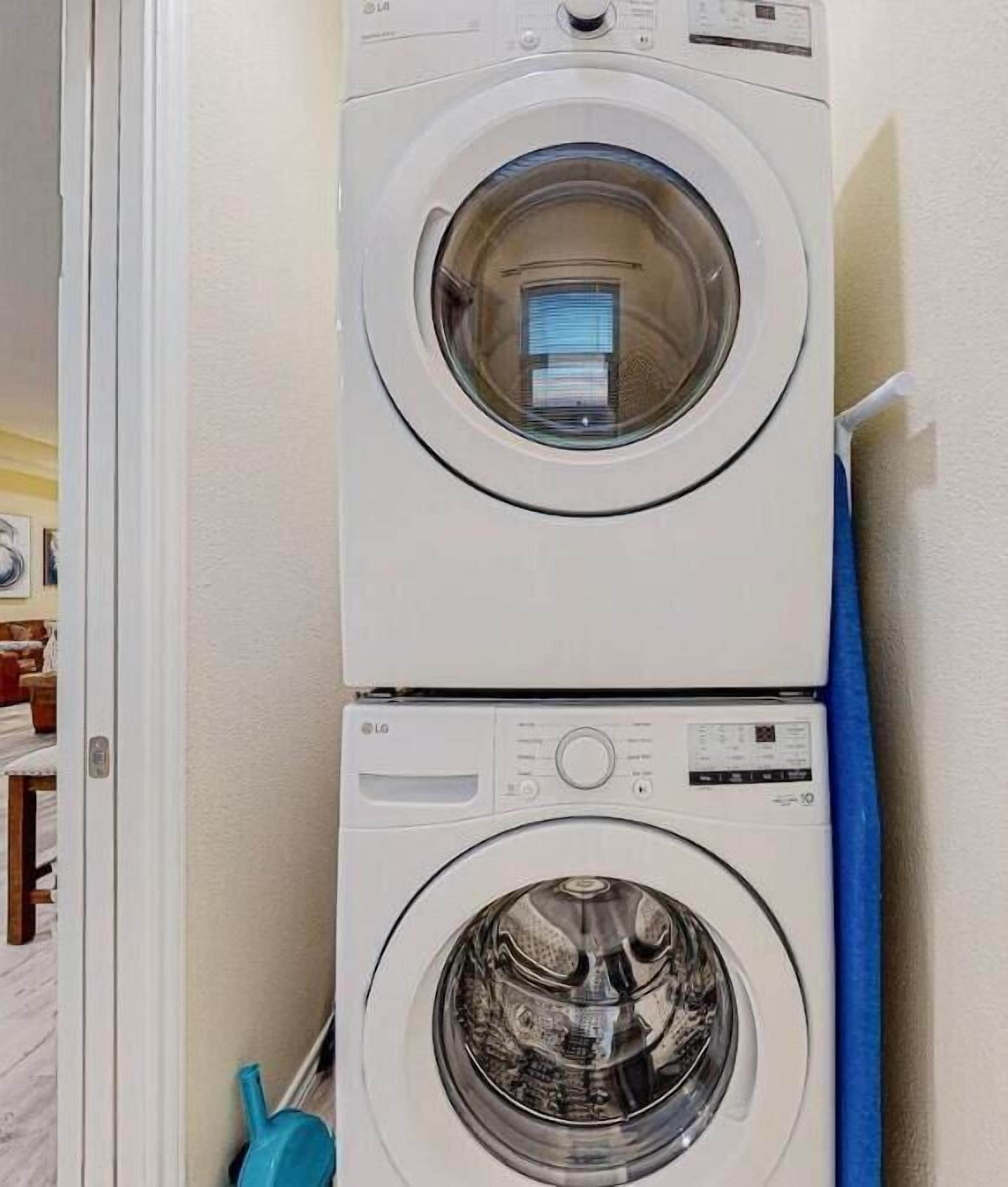 A stacked washer and dryer unit in a laundry room.