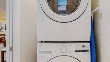 A stacked washer and dryer unit in a laundry room.