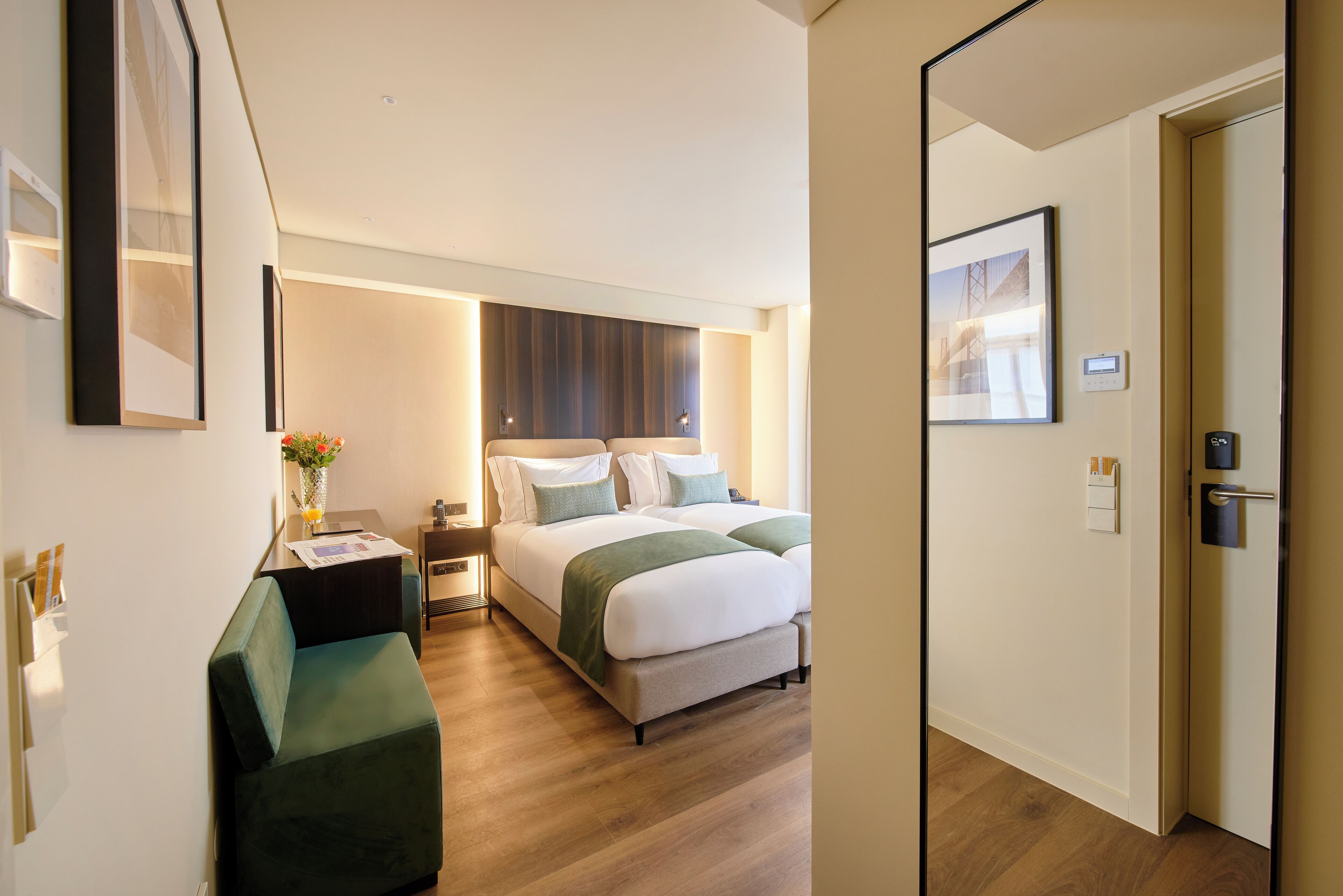 Une chambre d’hôtel avec un lit, un bureau, une chaise et une table de chevet.