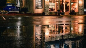 A building with a large sign for 'Laurel Mercantile' and 'Sartman' at night.