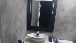 A bathroom with a white sink, a mirror, and a toilet. - Superb 2-bedroom villa in Mirissa (Mirissa)