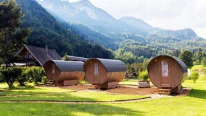 A cabin-style accommodation with three wooden cabins in a mountainous setting. - 4 Elements Resort Bled Studio Standard (Radovljica)