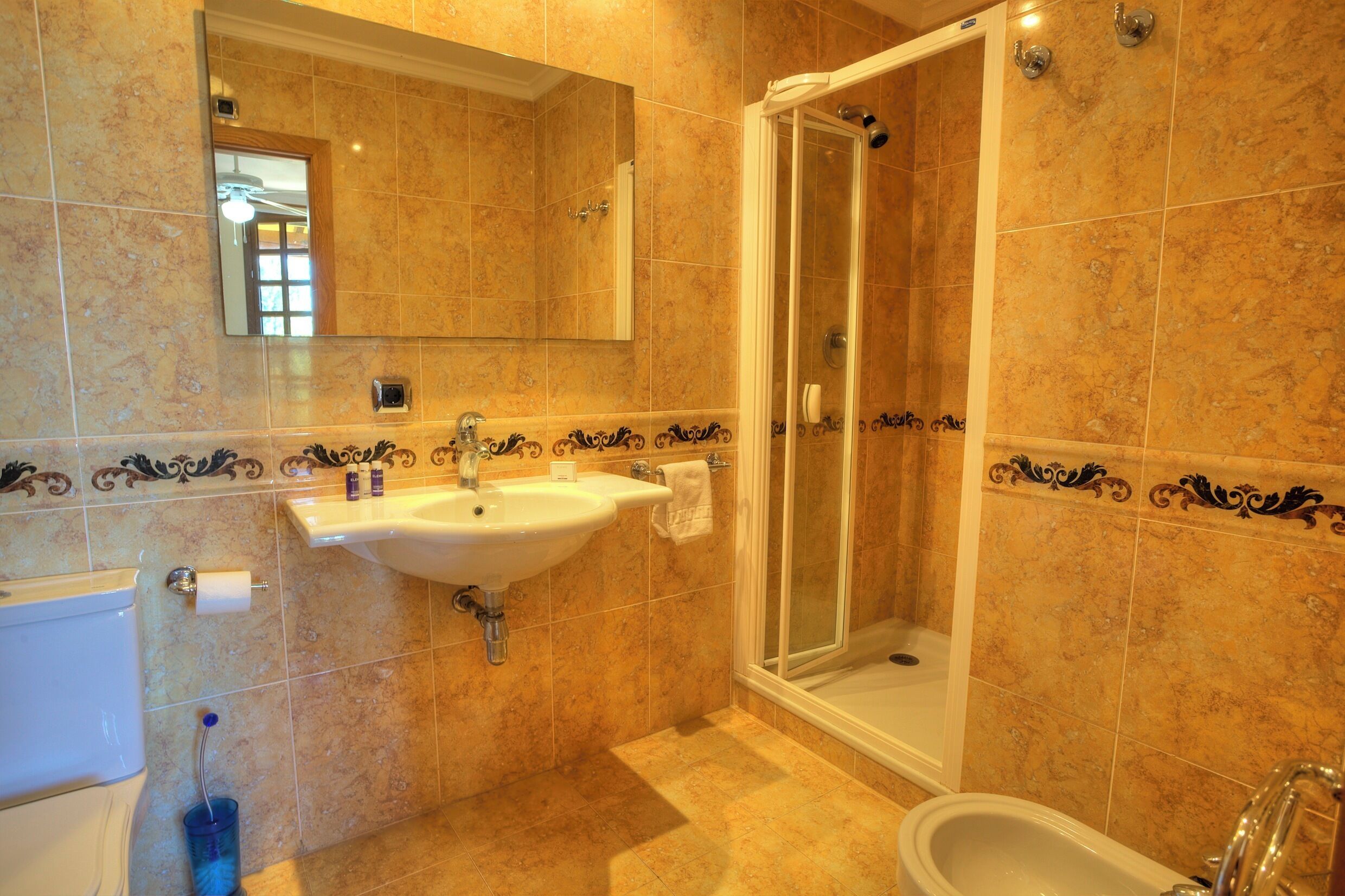 A bathroom with a sink, mirror, shower, and bathtub.