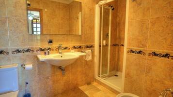 A bathroom with a sink, mirror, shower, and bathtub.