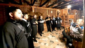 A group of people in traditional attire standing in a room with a tiled floor and wooden beams on the ceiling. - Hotel Oasis Villa (Tsqaltubo)