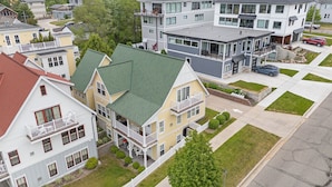 A residential area with a mix of modern and traditional houses, featuring balconies and front yards. - Family-Friendly 3BR Condo Grand Haven 27 (Grand Haven)