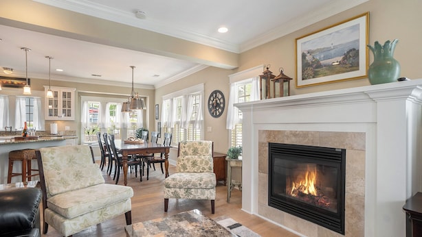 A spacious living room with a fireplace, dining area, and kitchen in the background. - Family-Friendly 3BR Condo Grand Haven 27 (Grand Haven)
