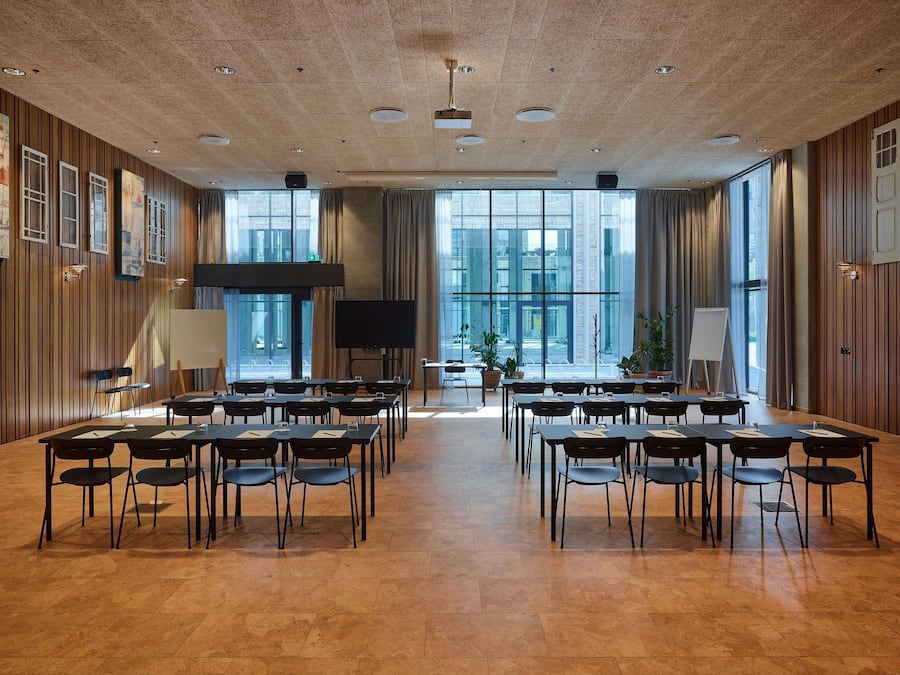 A conference room with a large table, chairs, a projector, and a whiteboard.