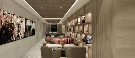 A modern interior with a long hallway, a seating area with a sofa and chairs, and a bookshelf with decorative items.