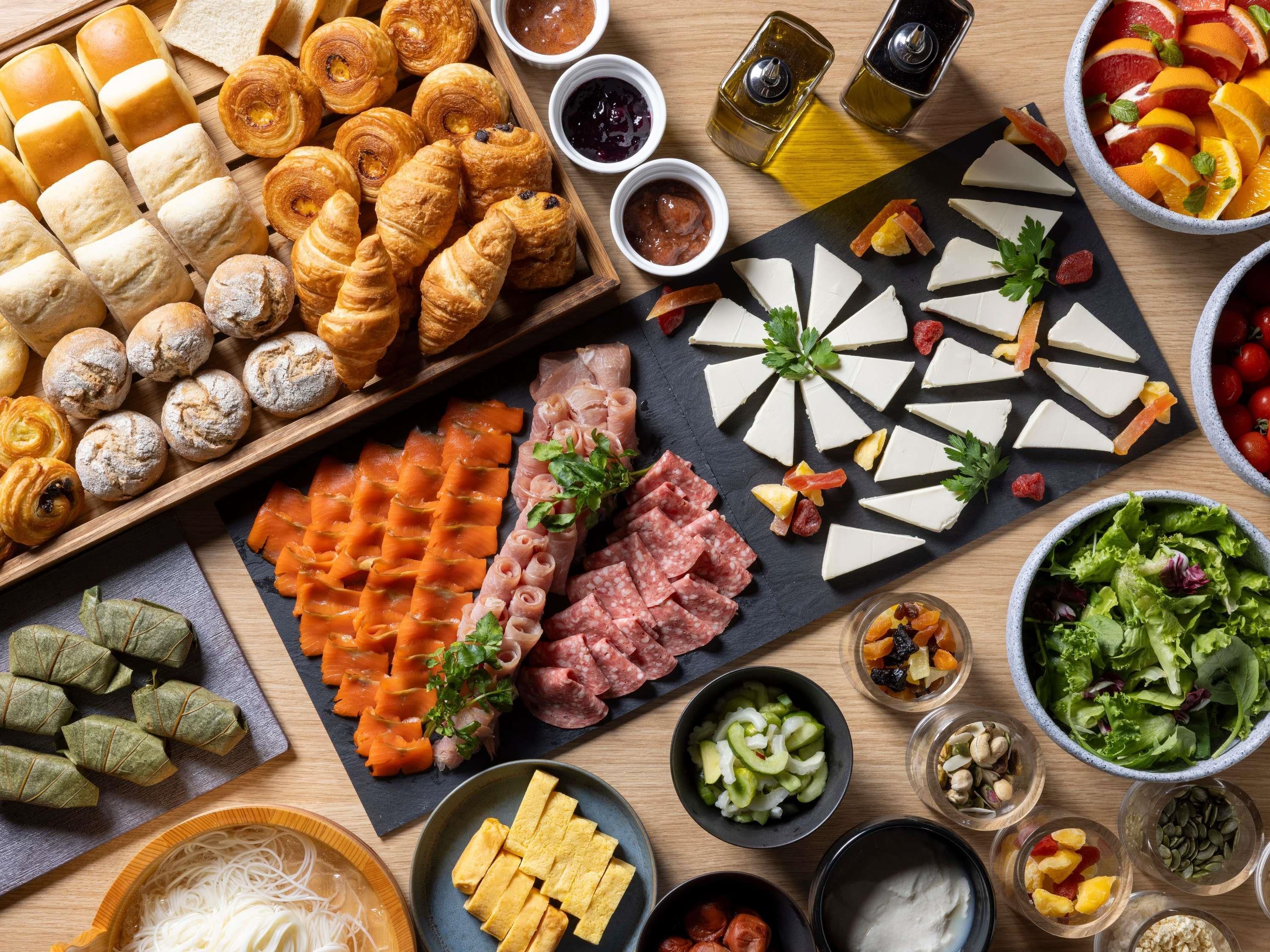 A variety of food items including pastries, cheeses, meats, and salads.