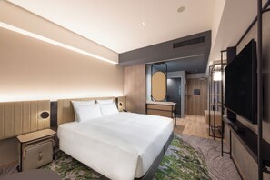 A modern hotel room with a large bed, a flat-screen TV, a desk with a mirror, and a walk-in closet. - Novotel Nara (Nara)