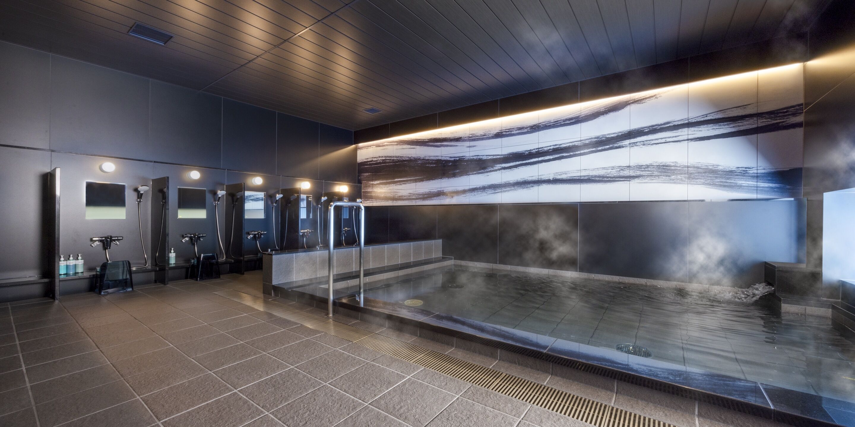 A modern bathroom with multiple sinks, a large heated pool, and a contemporary design.