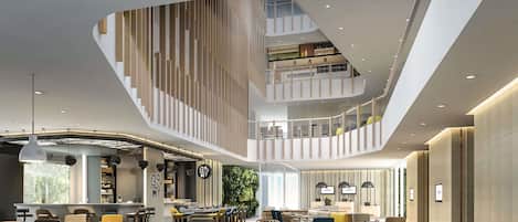 A multi-level interior with a central staircase, a bar area, and seating arrangements.