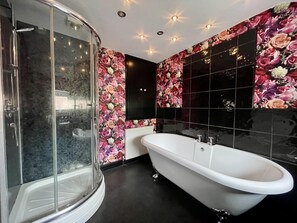 Bathroom features a glass-enclosed shower and bathtub.
