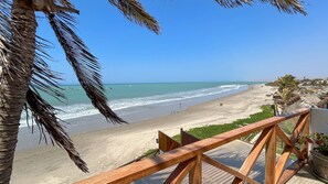Enjoy stunning ocean views from the balcony overlooking the sandy beach.