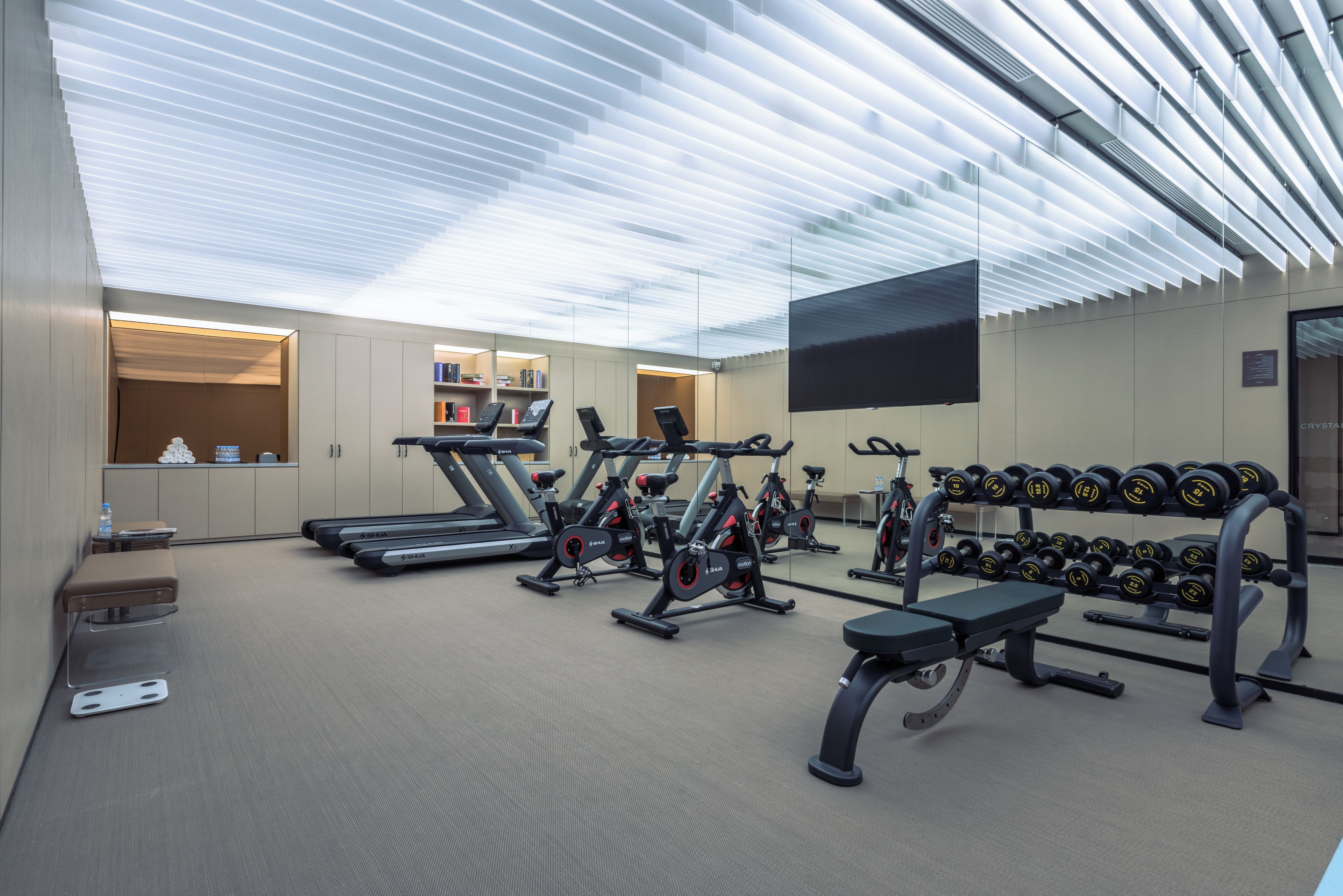 A gym with treadmills, stationary bikes, and weight equipment.