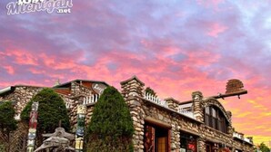 A stone building with a rustic design, featuring a large wooden door and a sign that reads "Leopold's." - Spirit Lake Retreat - Suite B (Harbor Springs)