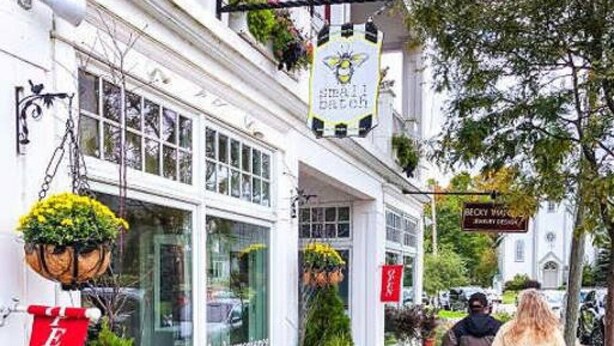 A building with a sign reading "TEN" and another sign with a bee logo.