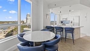 A modern kitchen with white cabinets, a large island, and a view of the city. - Fontain Miami Beach - Bayview Condo - We Host (Miami Beach)