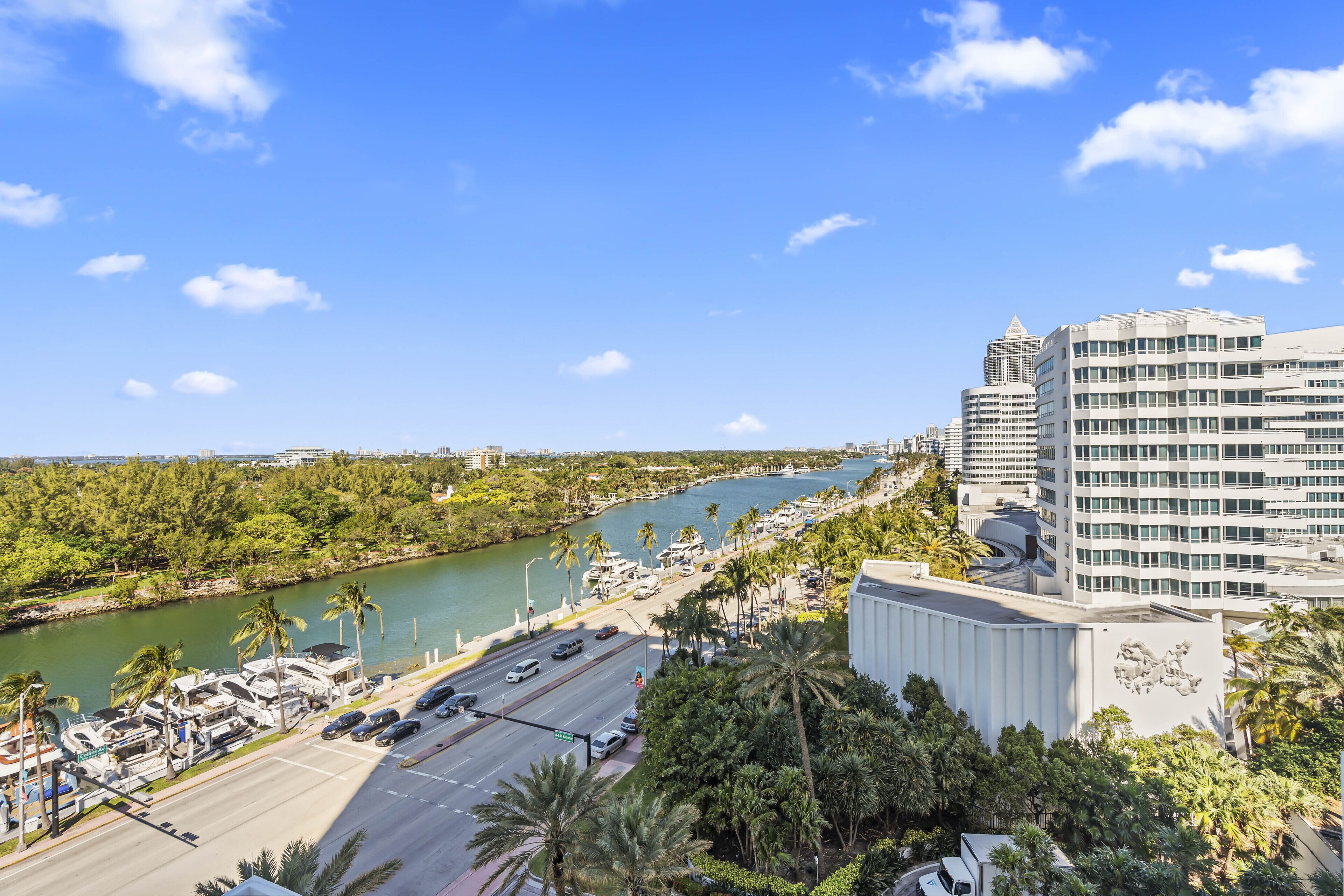 A high-rise hotel with a view of a marina and a river.
