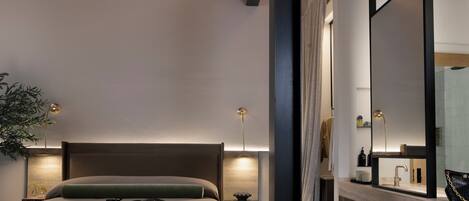 A modern bedroom with a large bed, bedside lamps, a nightstand, and a large mirror.