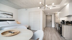 Relax in this stylish room with a large bed, kitchenette, and convenient amenities.