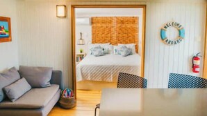 A cozy room with a bed, a sofa, and a dining table. - AMAZING Ensenada Honda View @ MAREA 1-1 - Punta Aloe #3 (Culebra)