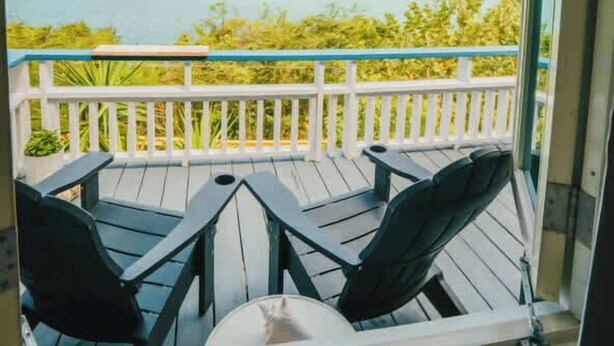 A covered outdoor seating area with a view of a lake and hills. - AMAZING Ensenada Honda View @ MAREA 1-1 - Punta Aloe #3 (Culebra)