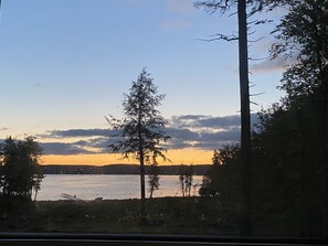 A view of a lake with trees and a dock.