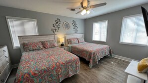 A bedroom with two beds, a ceiling fan, and a dresser. - Rivers Edge 102 (Helen)