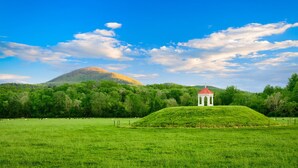 A green field with a white gazebo and a hill in the background. - Bavarian Brook Unit 8 (Helen)