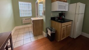 A compact kitchen with a sink, microwave, and refrigerator. - Bavarian Brook Unit 7 (Helen)