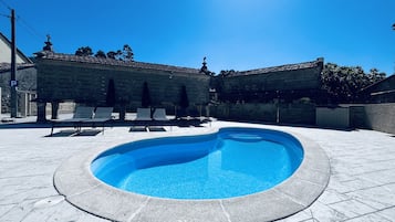 Seasonal outdoor pool, open 10:00 AM to 10:00 PM, pool umbrellas