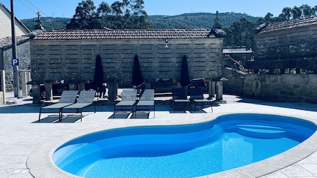 Seasonal outdoor pool, open 10:00 AM to 10:00 PM, pool umbrellas