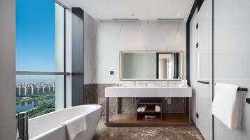 Deluxe Suite, 1 King Bed | Bathroom | Rainfall showerhead, designer toiletries, hair dryer, slippers