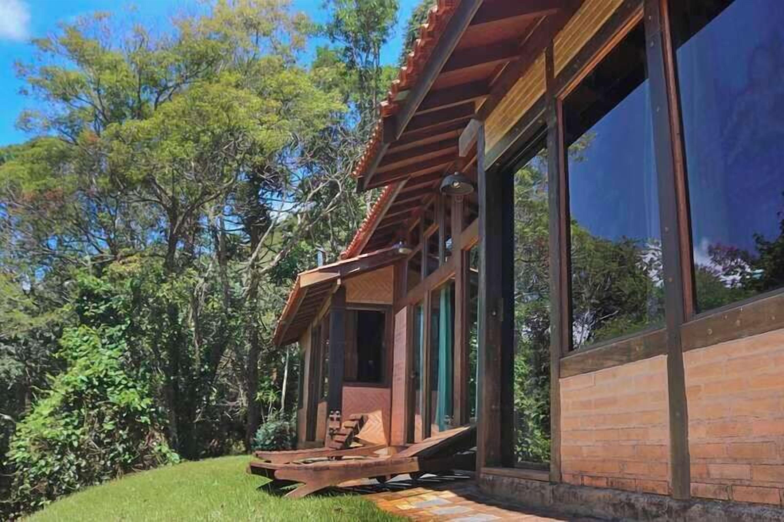 A modern building with large windows and a wooden deck.