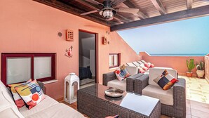 A sunlit patio with wicker furniture, a ceiling fan, and a view of the ocean. - Luxury and spacious 3-bed Penthouse apartment in fabulous Gualdalmansa (Gualdalmansa)